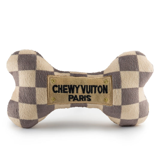 Checkered bone-shaped dog toy with 'Chewy Vuitton Paris' label on a white background