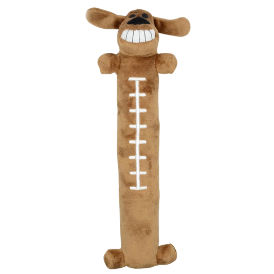 A brown plush dog-shaped pillow or toy with floppy ears, a wide toothy grin, and white stitched football-style laces down the center, shown on a plain white background.