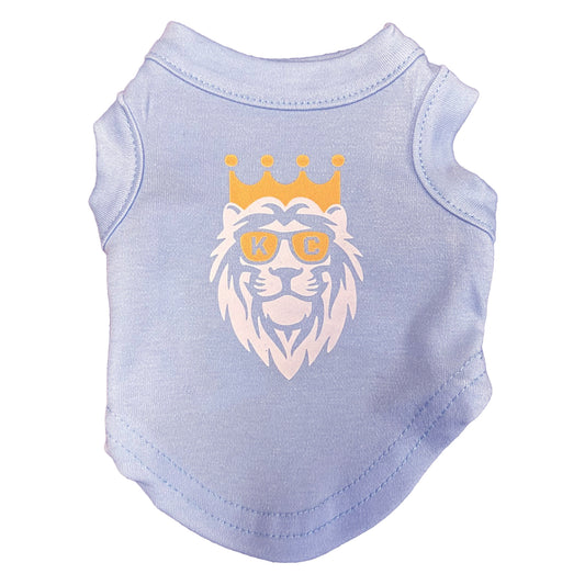 Light blue pet shirt with a lion graphic wearing sunglasses and a crown on a white background