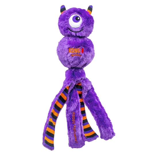 A purple plush monster dog toy with one large eye, small horns, and three striped rubber legs in orange, black, and purple. The toy has 'KONG MAX' and 'Halloween' printed on it, set against a plain white background.